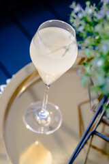 Beautiful yellow cocktail with an ice cube at a restaurant
