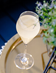 Beautiful yellow cocktail with an ice cube at a restaurant