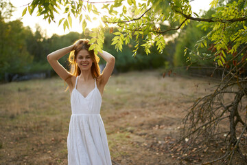 pretty woman in white dress in the field near the freedom tree