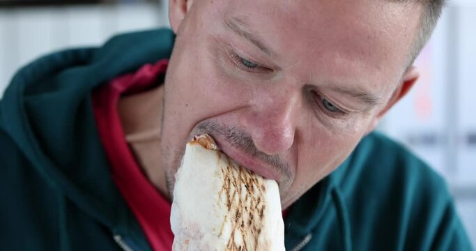 Young man eating delicious appetizing shawarma 4k movie