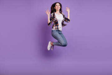 Fototapeta na wymiar Full length photo of young crazy girl happy positive smile jump up fly air isolated over violet color background