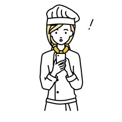 立ってスマートフォンを操作して何かに気づいて驚いた調理師の女性