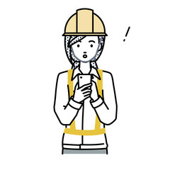 立ってスマートフォンを操作して何かに気づいて驚いた工事現場の女性