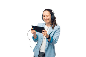 Smiling young lady is watching something on the tablet and listening in headphones.