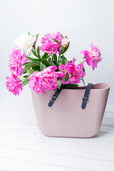 Fresh Flowers in a woman Handbag