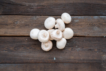 Raw champignons on the kitchen table flat lay background.