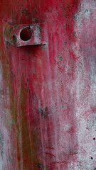 rectangular metal clamp welded onto old metal red and white rusty grungy metallic piece of equipment painted red but rusted and weathered old space for type with aged red paint in background backdrop 