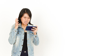 Fototapeta premium Playing Game on Phone With Angry Face of Beautiful Asian Woman Wearing Jeans Jacket and black shirt Isolated On White Background