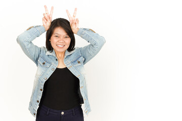Obraz premium Showing Peace or Victory Sign of Beautiful Asian Woman Wearing Jeans Jacket and black shirt Isolated On White Background