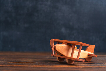 Wooden biplane toy on the background of the blackboard