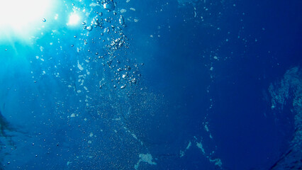 View of Air Bubbles underwater. Blue water and sun. Adriatic Sea	