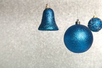 Shiny blue Christmas ball on glittering background