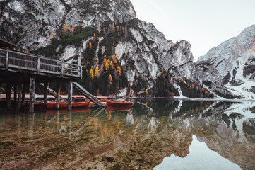 Amazing view of lake Lago di Braies in Dolomiti mountains. famous old wooden rowing boats on lake. South Tyrol, Italy.