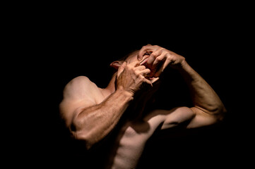 tearing his mouth open with his hands, dramatic photo