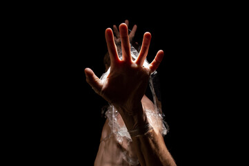 black and white photo, hands entangled in polyethylene