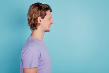 Profile side view portrait of cheerful guy good mood look empty space isolated on turquoise color background