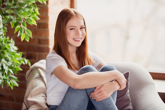Profile side photo of young attractive girl happy positive smile hug herself rest relax sut armchair indoors