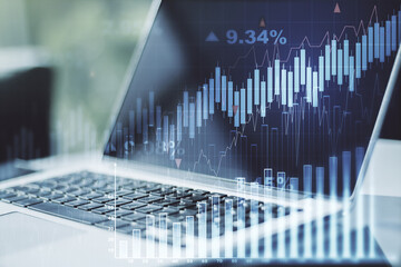 Multi exposure of abstract financial graph on laptop background, financial and trading concept