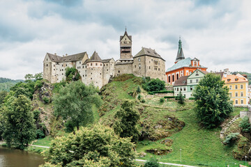 Fototapeta na wymiar Panoramic view of famous medieval town of Loket,Elbogen, with colorful houses and stone castle above river,Czech Republic.Historical city centre is national monument.Travel architecture background.