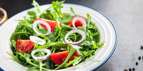salad arugula, tomato, onion fresh vegetable plate meal snack on the table copy space food background 