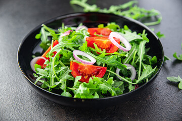 salad arugula, tomato, onion fresh vegetable plate meal snack on the table copy space food background 