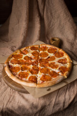 Delicious, aromatic, hot pepperoni pizza on brown background