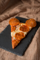 Delicious, aromatic, hot pepperoni pizza in the form of a mouse. Pizza for children. Pizza mouse