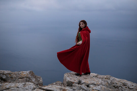 Woman in old fashioned clothes near sea
