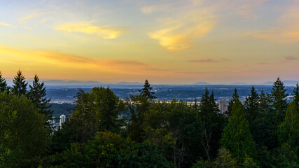 Sunrise over valley with distant view to mountains in silhouette.