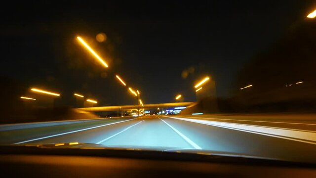 Time lapse fast motion of 4k UHD footage of driver POV on the almost empty highway driving fast with multiple light trails