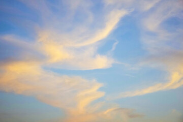 Fototapeta premium Unusual abstract pattern of cirrus clouds in sunset sky. Atmospheric phenomenon. Natural background. Copy space. Selective focus.