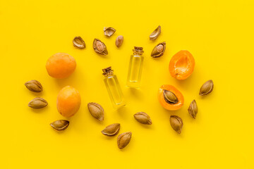Apricot kernel oil in glass bottles with ripe apricot fruits