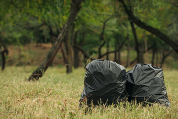 Trash bags full of garbage outdoors. Space for text