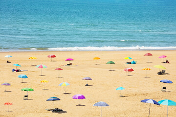 Many sunshade umbrellas on the sea beach resort