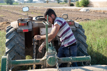 young farmer preparing the farm tools to start the cultivation of the orchard