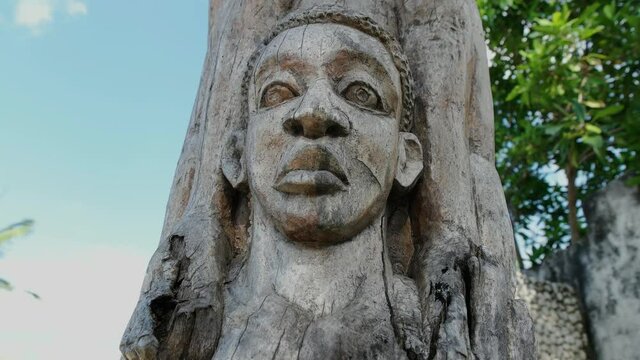 tree carving art statue with multiple faces