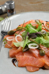 Delicious salmon carpaccio served on table, closeup