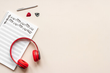 Music sheets with musical notes and headphones, top view