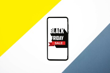 Smartphone on desk against black friday advert. Concept of sales, online shopping, and e-commerce.