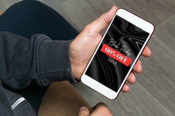 Hand holding cellphone with black friday text