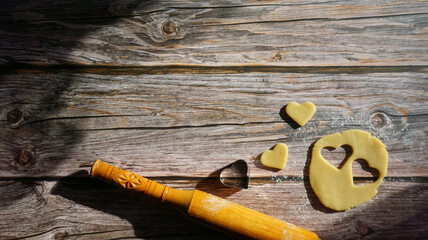 wooden rolling pin shortbread cookie cutter in the shape of a heart on a wooden surface summer...