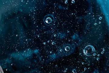 Liquid smear,cosmetics swatch on the navy blue background.Top view,antibacterial liquid surface.Good as background or mockup,large banner.