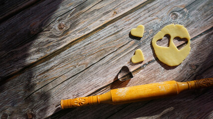 wooden rolling pin shortbread cookie cutter in the shape of a heart on a wooden surface summer...