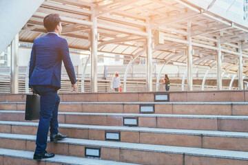 Fototapeta premium Young businessman walking in city for going to work with cityscape background.