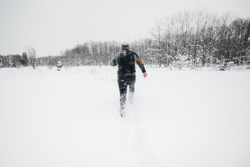 Couple playing with snow in the forest