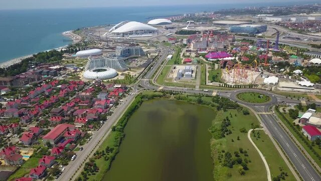 Sochi, Russia - 20 June, 2021: Olympic Flame, Fisht Arena, Adler Arena, Ice Sports Iceberg. Olympic Park in Sochi. Sirius Territory, Aerial View Hyperlapse