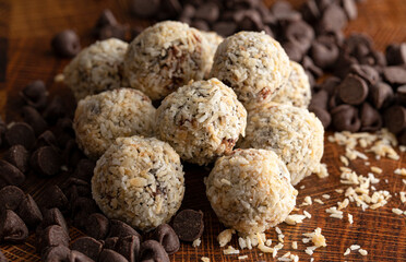 Group of Coconut Chocolate Energy Balls on a Wooden Butcher Block