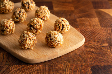 Group of Chocolate Peanut Butter Energy Balls on a Wooden Butcher Block