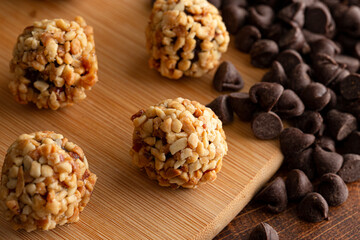 Group of Chocolate Peanut Butter Energy Balls on a Wooden Butcher Block