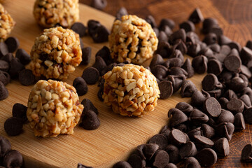 Group of Chocolate Peanut Butter Energy Balls on a Wooden Butcher Block